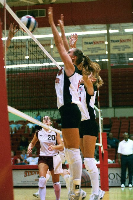 Jennie Glassey (left) and Andrea Darr (right) go for the block - Photo by Jim Veneman