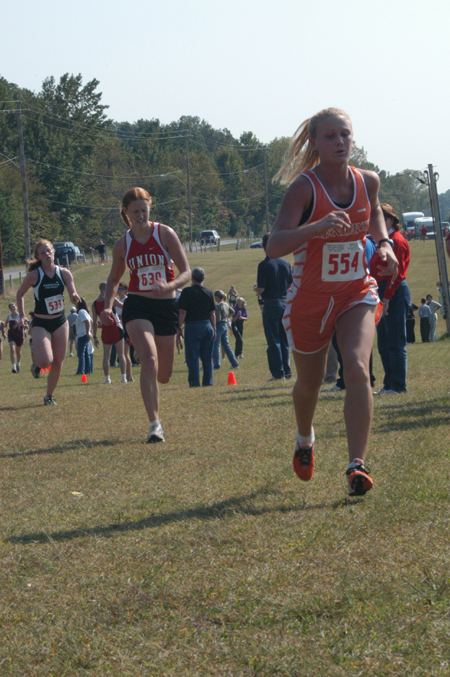 Junior Rachel Cazalas strains toward the finish line during a meet. - Photo by Lindsay Stavish