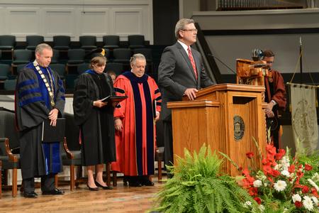 Norman Hill starts the summer commencement with the invocation. - Photo by Morris Abernathy