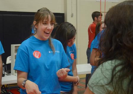 Laina Willoughby, Resident Advisor and sophomore nursing major, assists new students on move-in day in Fred DeLay Gymnasium. - Photo by Meg Rushing