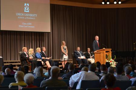 Todd McWilliams, Pharmacy Supervisor Emerging Leader for CVS/Caremark, addresses pharmacy students at the White Coat Ceremony in the G.M. Savage Memorial Chapel. - Photo by MiKalla Cotton