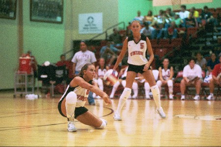 No. 8 Jennie Glassey (junior, Carlsbad, CA) recieves a shot while No. 5 Andrea Darr (senior, Swansea, IL) looks on - Photo by Jim Veneman