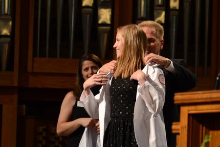 Willemijn Veldhuijzen, class of 2018 pharmacy student, receives her white coat at the White Coat Ceremony. - Photo by Meg Rushing