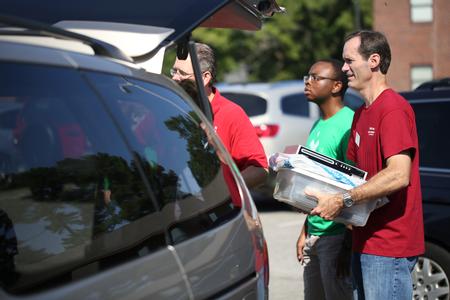 Mark Stephens, assistant dean for experiential education, helps new students move into their rooms on campus. - Photo by Kristi McMurry Woody