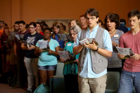 Students, faculty and staff join together and sing "Joyful, Joyful We Adore Thee" at the end of Fall Convocation. - Photo by Kristi McMurry Woody