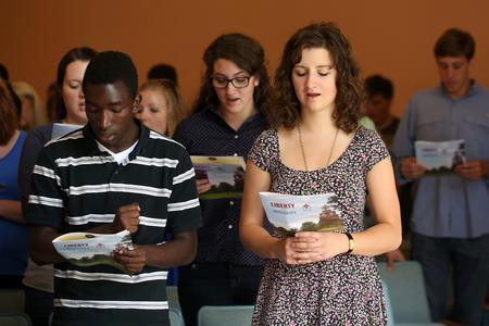 Students, faculty and staff join together and sing "Joyful, Joyful We Adore Thee" at the end of Fall Convocation. - Photo by Kristi McMurry Woody