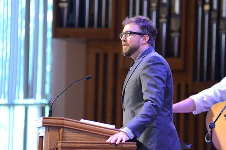 Taylor Worley, assistant vice president for university ministries, opens the chapel service at G.M. Savage Memorial Chapel. - Photo by Meg Rushing