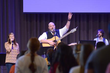 Callie Sheehan, junior elementary education major, Russ Pflasterer, pastor of City Fellowship Church, and Rob Griffith, senior english major, lead music during chapel. - Photo by Meg Rushing