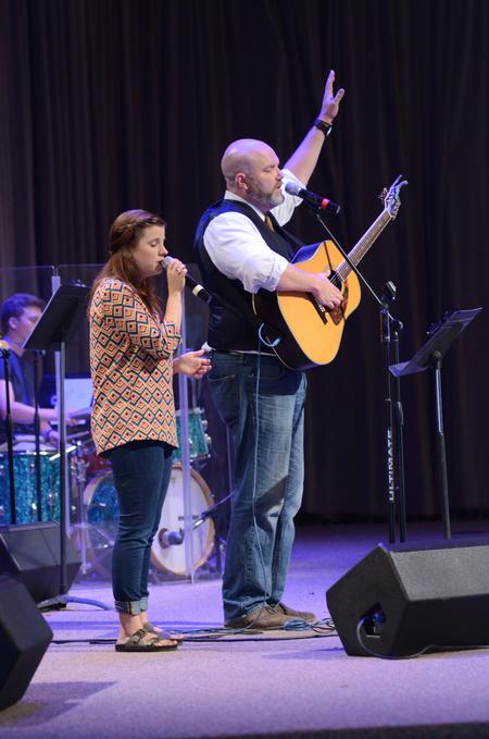 Callie Sheehan, junior elementary education major, and Russ Pflasterer, Pastor of City Fellowship Church, sing in the chapel service at G.M. Savage Memorial Chapel. - Photo by Meg Rushing