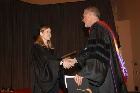 SGA President Kristin Ulmer presented Kelvin Moore with the Faculty Member of the Year award. - Photo by Jim Veneman