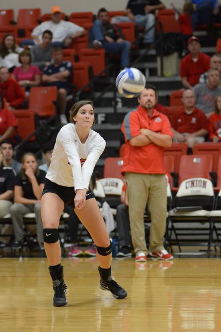 Abbey Wainwright, senior nursing major, prepares to hit the volleyball back over the net to the girls from Mississippi College. - Photo by Emily Stookey