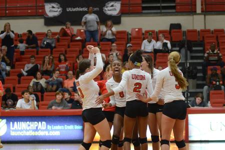 The Lady Bulldog volleyball team celebrates their three set victory against Mississippi College. - Photo by Emily Stookey