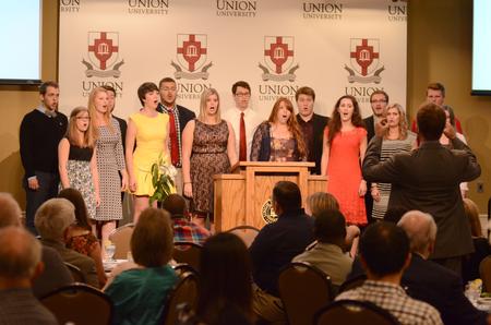 Proclamation, a student vocal group, performs several songs under the direction of Chris Mathews, chair of the department of music, for the guests of the West Tennessee Pastors and Wives Appreciation Banquet. - Photo by Emily Stookey