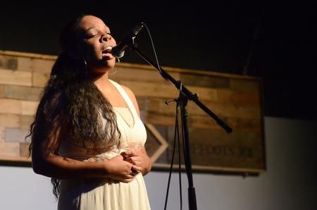 Angelica Shipps, sophomore public relations major, sings "My Head is as Big as the Universe," by The Flying Colours for Open Mic in Barefoots Joe. - Photo by Emily Stookey