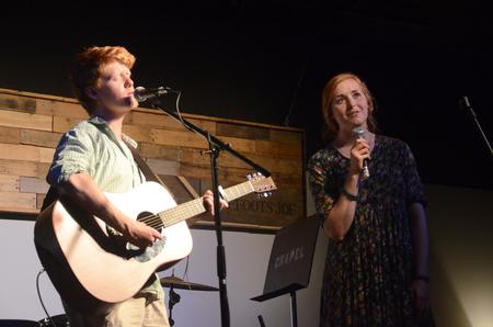 Connor Johnson, sophomore christian studies major, and Kelsey Leaf, junior public relations major, sing a duet for Barefoots Joe's Open Mic.  - Photo by Emily Stookey