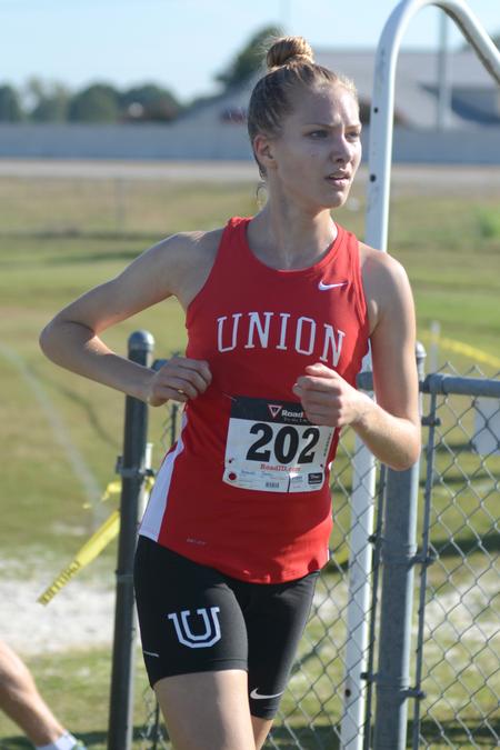 Freshman Janey Berends runs in a cross country meet. - Photo by Meg Rushing
