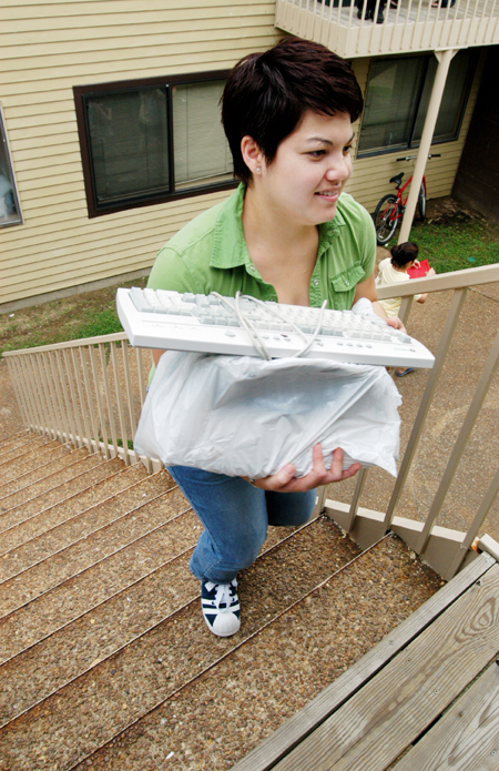 Gwyn Bell, computing services secretary, helps new students move in to the dorms. - Photo by Kristen Hiller