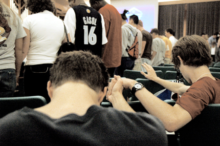 New students join together in prayer during the FOCUS worship service on Saturday evening. - Photo by Lindsay Stavish