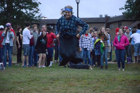 Freshmen compete in a sack race at the annual DF Olympics on the Heritage Complex lawn. - Photo by MiKalla Cotton