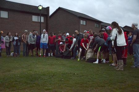 Freshmen guys compete in the sack race at the annual DF Olympics on the Heritage Complex lawn. - Photo by MiKalla Cotton