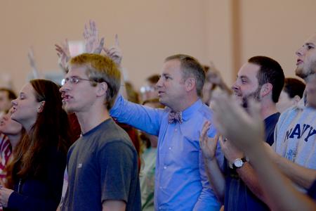 Dub Oliver, president of the university, enjoys worship with university students.  - Photo by Emily Stookey
