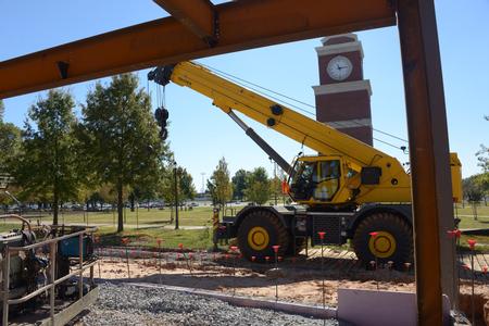 Each day more steel goes up on the Construction site.  Construction workers position the crane to hang more steel beams.  Some of the beams weigh as much as 10,000 pounds and are 30 feet long. - Photo by Morris Abernathy