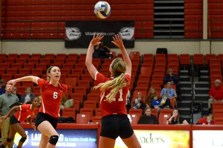 Sophomore setter, Hannah Huguley, sets to Mallory Baker, senior middle hitter. - Photo by Meg Rushing