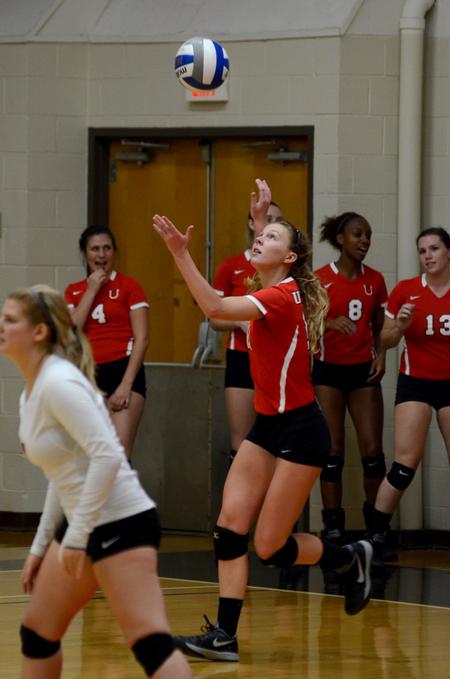 Hannah Huguley, sophomore setter and right side hitter, serves the ball in a match against Williams Baptist College. - Photo by Meg Rushing