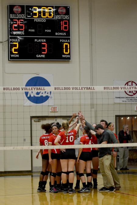 The women's volleyball team huddles after defeating Williams Baptist College. - Photo by Meg Rushing