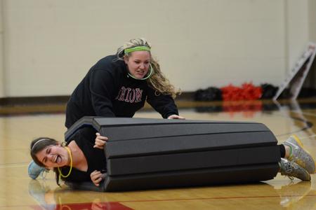 Abby Duke, junior public relations major, and Emily Russell, senior psychology major, compete in a minute-to-win-it game at Bulldog Madness. - Photo by Meg Rushing