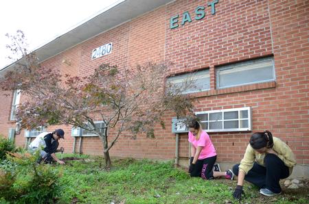 Junior council members, Gray Magee, junior cell and molecular biology major, Kelley Faulkner, junior biochemistry major, and Clare Williams, junior intercultural studies major, serve at East Elementary School for Campus and Community Day. - Photo by MiKalla Cotton