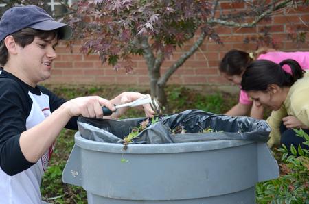 Junior council members, Gray Magee, junior cell and molecular biology major, Kelley Faulkner, junior biochemistry major, and Clare Williams, junior intercultural studies major, serve East Elementary School by doing yard work for Campus and Community Day. - Photo by MiKalla Cotton