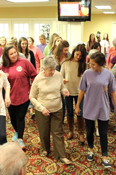 Members of Chi Omega dance with Regency Retirement Village residents on Campus and Community Day. - Photo by Meg Rushing
