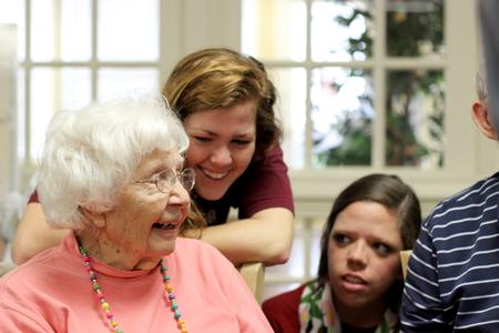 Sydney Jensen, sophomore nursing major, and Breanne Crain, junior marketing major, speak with a resident of Regency Retirement Village on Campus and Community Day. - Photo by Meg Rushing