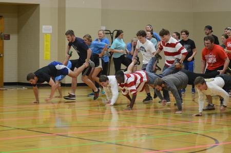 Student organization teams compete in a wheelbarrow race at Bulldog Olympics. - Photo by Meg Rushing