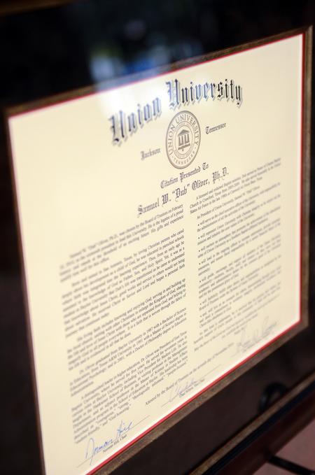 The framed citation was presented to Samuel W. "Dub" Oliver during Union University's 16th presidential inauguration in the G.M. Savage Memorial Chapel. - Photo by Kathleen Murray