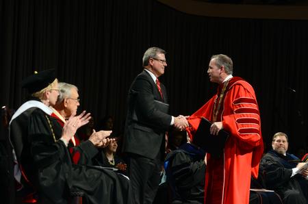 Norman Hill, standing left, Board of Trustees Chair, congratulates Samuel W. "Dub" Oliver, during Union's 16th presidential inauguration. - Photo by Kathleen Murray
