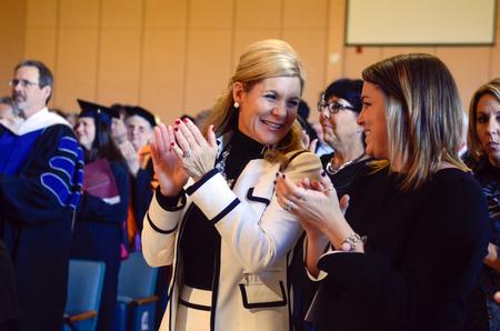 Susie and Callie Oliver, wife and daughter of Dub Oliver, excitedly clap at the end of the inauguration ceremony in the G. M. Savage Memorial Chapel. - Photo by Kathleen Murray