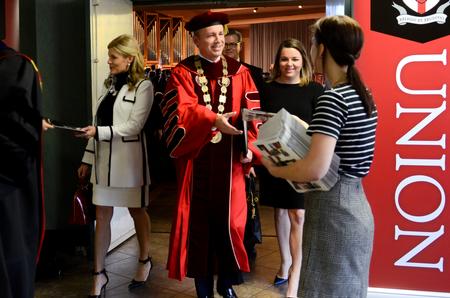 As the first family of Union University exits the inauguration ceremony, they are greeted with the first copies of the first edition of the Cardinal & Cream's newest production, the C&C magazine. - Photo by Kathleen Murray