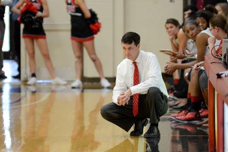 Women's head basketball coach, Mark Campbell, watches his team from the sidelines during the Homecoming game against Robert Morris University.  - Photo by Emily Stookey