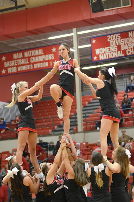 Bulldog cheerleaders perform for the crowd between the girls and boys Homecoming basketball games.  - Photo by Emily Stookey