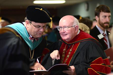 Employees and guests mingle in the hallway before entering the presidential inauguration of Dub Oliver, the university's 16th president, held in the G. M. Savage Memorial Chapel.  - Photo by Emily Stookey