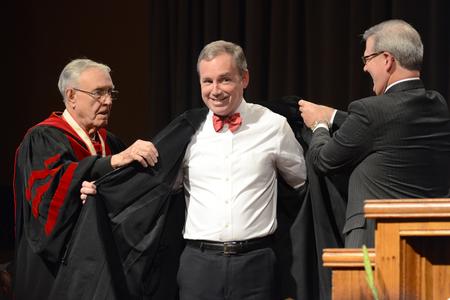 Dub Oliver, Union University's 16th president, prepares to put on his new regalia at the inauguration ceremony. - Photo by Emily Stookey
