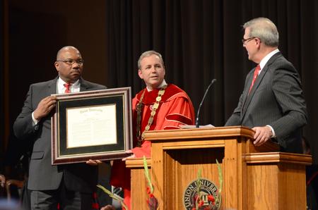 James Ross, left, chief operating officer for West Tennessee Healthcare, and Norman Hill, right, Board of Trustees Chair, present the citation to Dub Oliver, center, Union University's newly inaugurated 16th president, during the ceremony in the G. M. Savage Memorial Chapel. - Photo by Emily Stookey