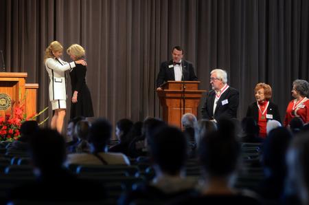 Susie Oliver, first lady, helps award members of the Class of '65 in chapel. - Photo by Amanda Rohde