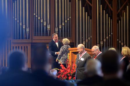 Dub Oliver, president of the university, shakes hands with members of the Class of '65 as they are recognized on stage in chapel. - Photo by Amanda Rohde