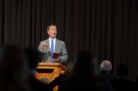 Chris Mathews, associate professor of music and department chair, leads in singing the Alma Mater during homecoming chapel. - Photo by Amanda Rohde
