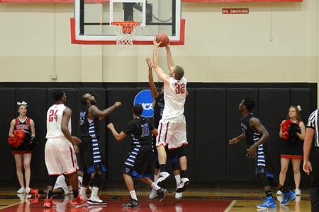 Eric Leisey, junior forward, rebounds a ball in the homecoming game against Williams Baptist. - Photo by Meg Rushing