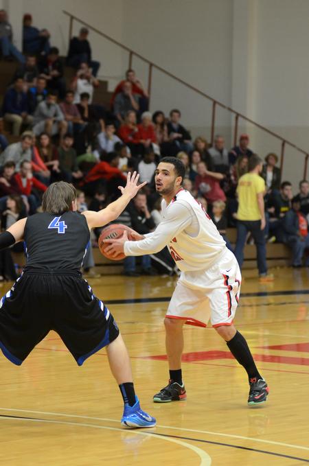 Senior guard, Pedro Faller, looks for a pass in the homecoming game against Williams Baptist in Fred Delay Gymnasium. - Photo by Meg Rushing