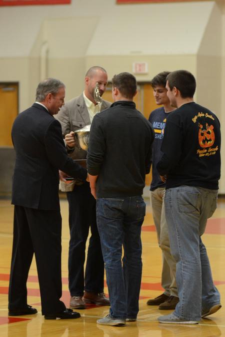 Dub Oliver, president of the university, and Brian Carrier, vice president for student life and dean of students, present the President's Cup to the men of Sigma Alpha Epsilon at the Homecoming game. - Photo by Meg Rushing